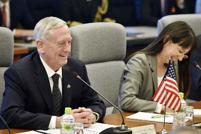 U.S. Defense Secretary Jim Mattis, left, smiles while speaking to Japanese Defense Minister Tomomi Inada, unseen, at the start of their meeting at Defense Ministry in Tokyo on Saturday.
