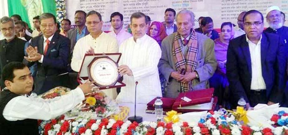 Chairman of the Parliamentary Standing Committee on Ministry of Railway ABM Fazle Karim Chwodhury MP handing over crest to Urkirchar UP Chairman Syed Abdul Jabbar Sohel at the inaugural function of Urkirchar UP Complex on Friday evening.