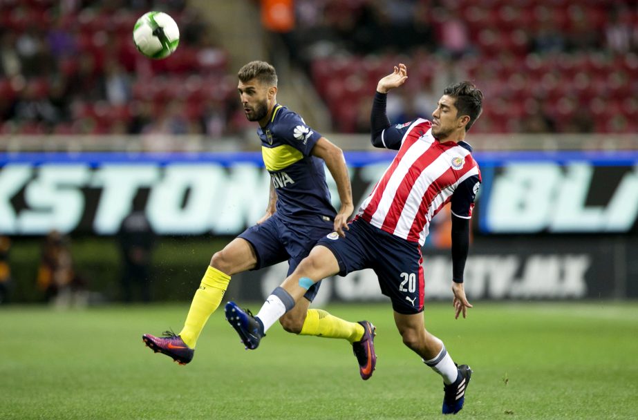 Gino Peruzzi of Argentina's Boca Juniors and Rodolfo Pizarro of Mexico's Chivas, compete for control of the ball during the friendly soccer match in Guadalajara, Mexico on Thursday.