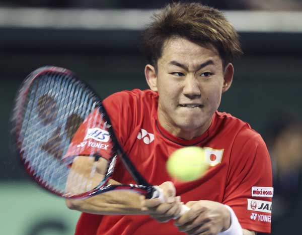 Japan\'s Yoshihiko Nishioka returns the ball against Gilles Simon of France during their Davis Cup World Group first round tennis match in Tokyo on Friday.