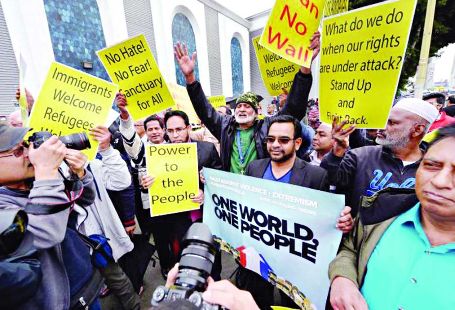 People hold signs after attending Friday prayers, to show solidarity with the Muslim community, at the Islamic Center of Southern California in Los Angeles, California, US on Friday.