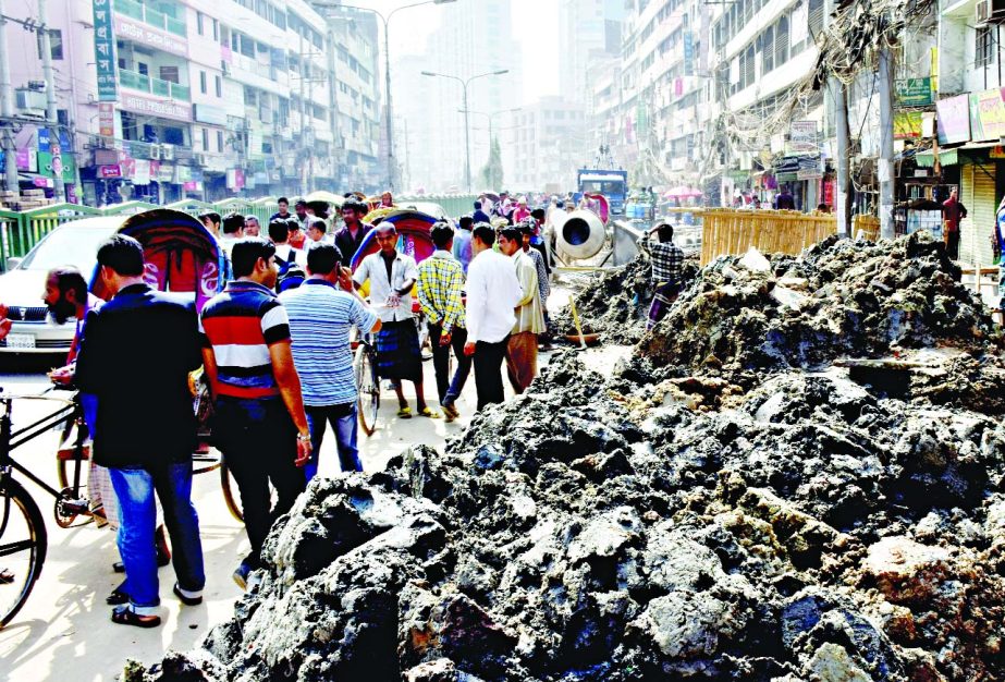 Road digging is a common phenomenon in city. Photo shows mud being dumped after digging the main thoroughfare at Fakirerpool causing sufferings to movement of vehicles and pedestrians. But the authorities concerned did not take any step to remove those.
