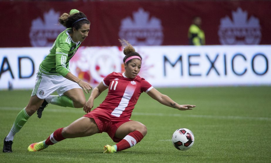 Canada's Desiree Scott (11) vies for control of the ball with Mexico's Ariana Calderon during the second half of an international friendly soccer match in Vancouver, British Columbia on Saturday.