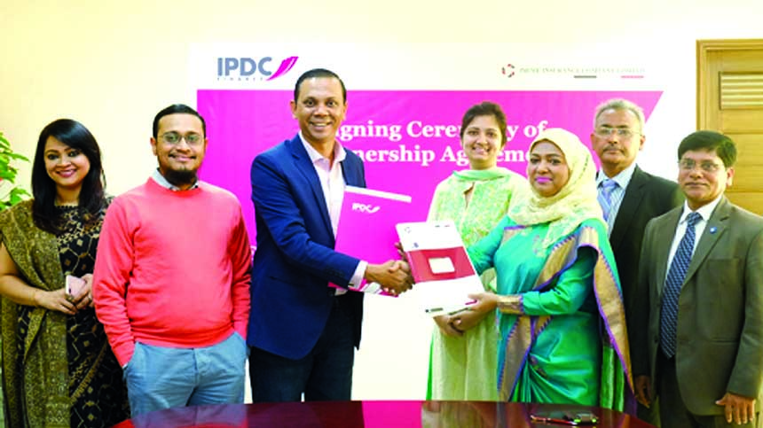 Mohammodi Khanam, CEO of Prime Insurance Company (PIC) and Mominul Islam, CEO of IPDC Finance Limited exchanging documents after signed a deal at IPDC head office in the city recently. AFM Barkatullah, Deputy Managing Director, IPDC Finance Ltd, Syed Moni