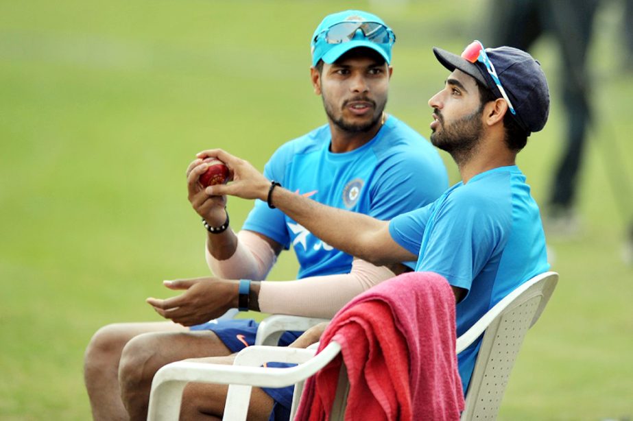 India's bowlers Umesh Yadav(L) and Bhuvneshwar Kumar share a light moment during a team practice session on the eve of a Test match between India and Bangladesh at the Rajiv Gandhi International Cricket Stadium in Hyderabad on Wednesday. India play one