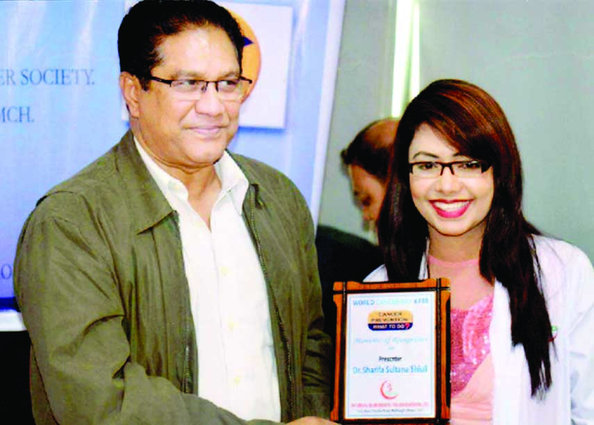 Director (Administration) of Dr Sirajul Islam Medical College Hospital Dr Zahedul Alam handing over a citation crest to Dr Sharifa Sultana Sheuly for her presentation at a seminar on 'Resisting Cancer and Our Role' at a ceremony held in the college on