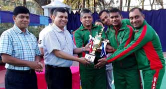 Assistant Chief of Air Staff (Administration) Air Vice Marshal Masihuzzaman Serniabat handing over the trophy to the BAF Bashar Base team, which emerged as the champions of the Inter-Base Lawn Tennis Competition of Bangladesh Air Force at the BAF Zahurul