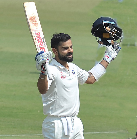 India's captain Virat Kohli raises his bat for his double century (200 runs) on the second day of the Test cricket match between India and Bangladesh at the Rajiv Gandhi International Cricket Stadium in Hyderabad on Friday.