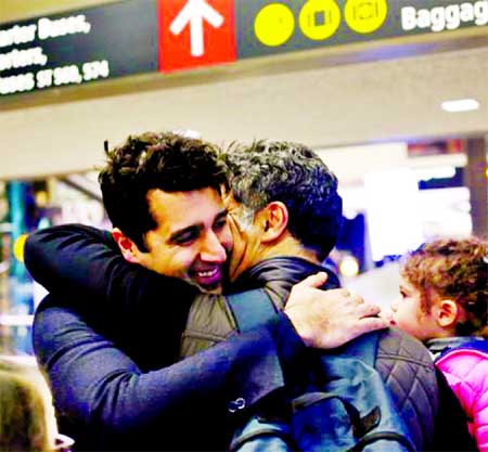 Iranian citizen and U.S green card holder Cyrus Khosravi (L) greets his brother, Hamidreza Khosravi after they were detained for additional screening following their arrival to Seattle-Tacoma International Airport. Internet photo