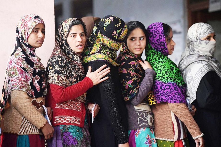 Muslim women queue to cast their votes at a polling station in Muzaffarnagar, India's Uttar Pradesh State on Saturday.