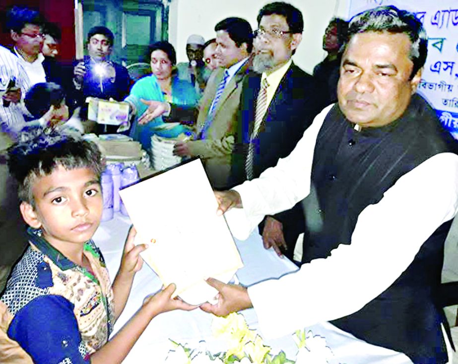 BANARIPARA (Barisal): Adv Talukder Md Yusuf MP giving prize to Rudro, a student of Class IV of Nalsi Govt Primary School who obtained 1st position in Palligeeti in Barisal Division recently.