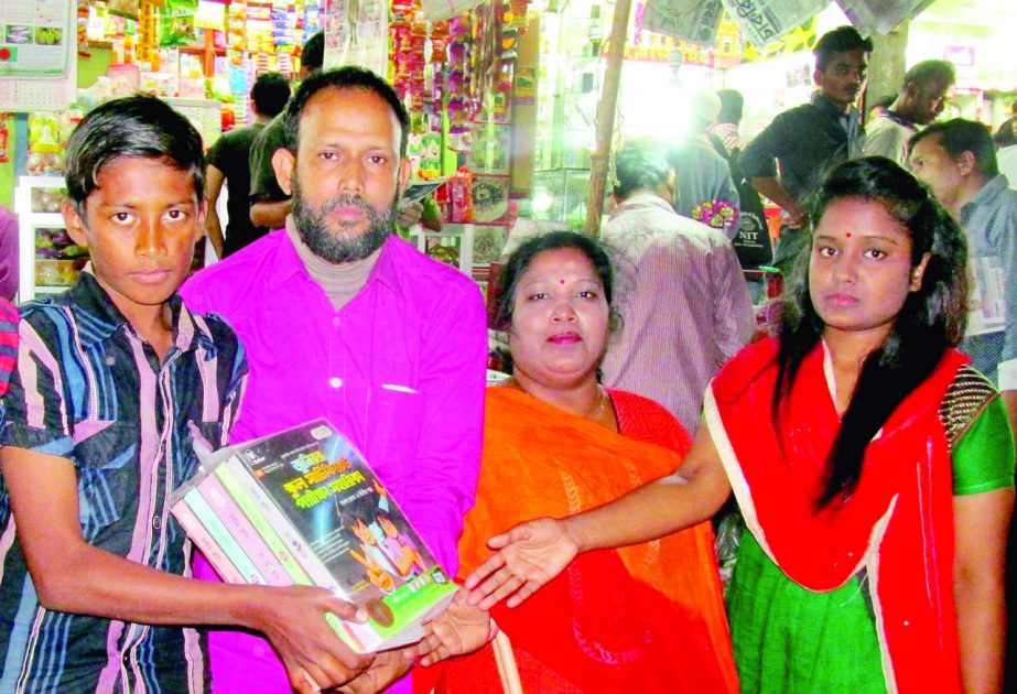 Lion Dr Barun Kumar Acharjo Bolai distributing free books among the poor students organised by Maizbhandari Gousia Haq Committee Bangladesh, Surjogini Branch recently.