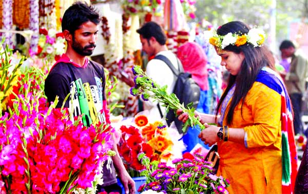 Flower-lovers crowded stalls at Shahbagh Avenue on Monday marking Pahela Falgun and Valentine's Day today.