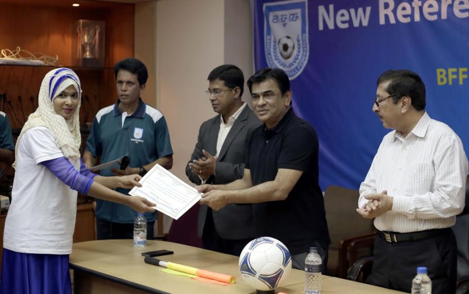 President of Bangladesh Football Federation (BFF) Kazi Salahuddin distributes a certificate to a new referee at the conference room of BFF House on Tuesday. BFF organized a new referees' training course.