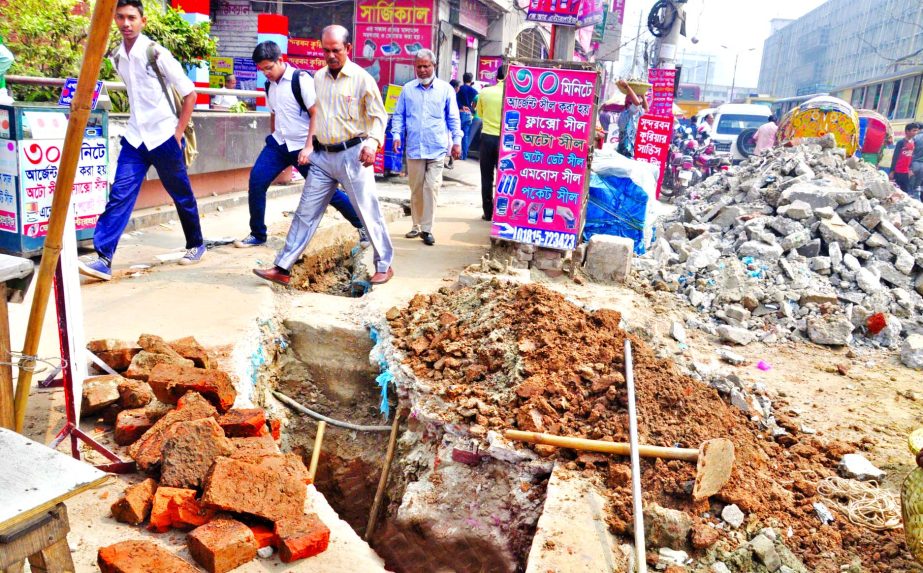 Digging of roads for utility lines at a snail's pace in different areas of the city makes the life of pedestrians miserable and also movement of vehicles. This photo was taken from city's Topkhana Road area on Tuesday.