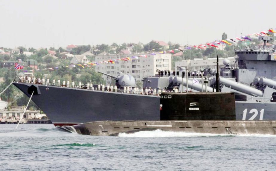 The Rostov-On-Don submarine sails past the guided missile cruiser Moskva during the Navy Day celebrations in Sevastopol, Crimea.