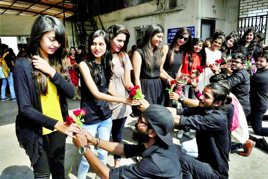 Boys give roses to girls on Valentine's Day in Surat, India.