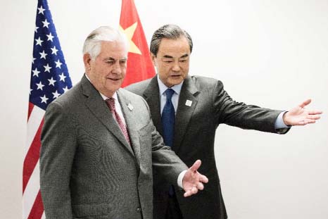 US Secretary of State Rex Tillerson (left) and China's Foreign Minister Wang Yi take their seats before a meeting at the World Conference Center in Bonn, Western Germany, on Friday.