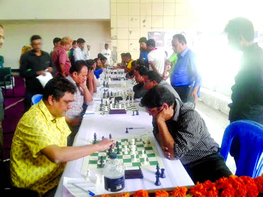GM Ziaur Rahman moves a pawn against Syed Mahfuzur Rahman during the International Mother Language Day International Rating Chess Tournament at Sonargaon Upazila Parishad auditorium in Sonargaon, Narayanganj on Friday.