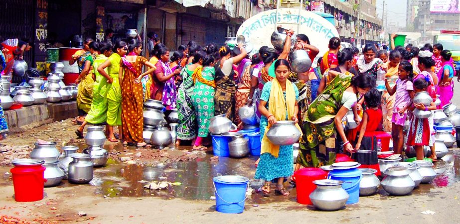 Hundreds of dwellers waiting with jars for collecting pure water as DWASA supply on limited scale in city's Sweeper Colony. This photo was taken from Swamibagh area on Friday.