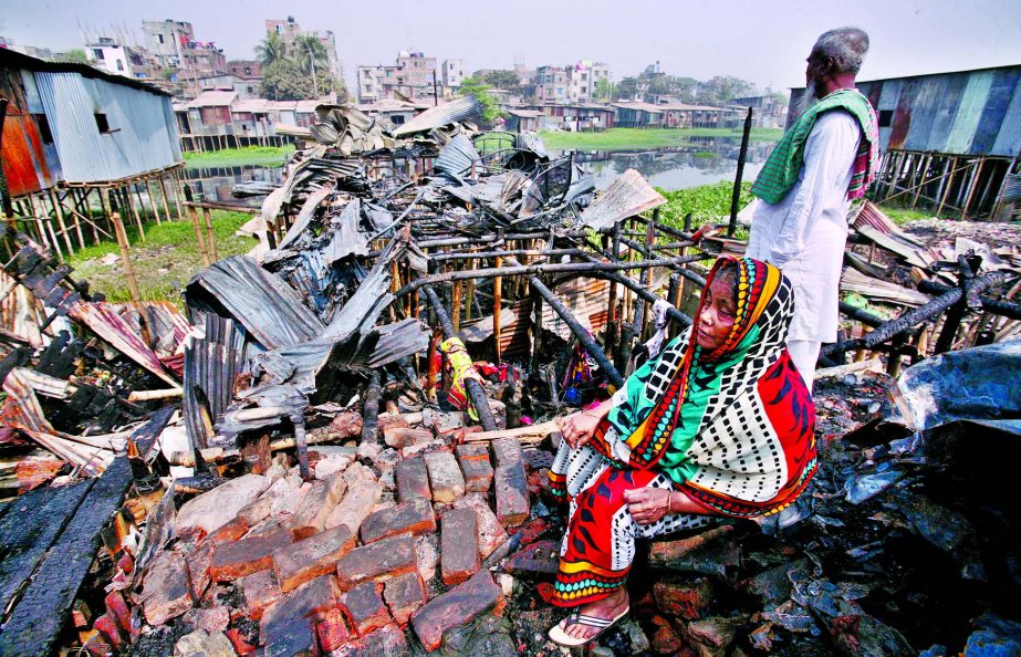 Affected people passing their days in the open sky as about 200 shanties were gutted with their belongings at Bansbaria slum in Mohammadpur on Thursday. This photo was taken on Friday.