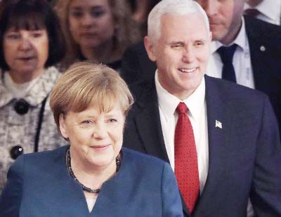 German Chancellor Angela Merkel, left, and United States Vice President Mike Pence arrive at the Munich Security Conference in Munich, Germany on Saturday.