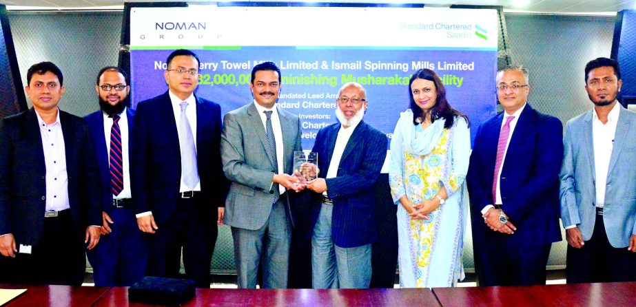 Standard Chartered Bank has arranged $32 million Diminishing Musharakah Facility for Noman Terry Towel Mills Limited and Ismail Spinning Mills Limited, two concerns of Noman Group. Md Nurul Islam, Chairman Noman Group, receiving a crest marking the signin