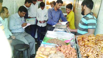 SYLHET: Members of a mobile court in Sylhet examining food products in a restaurant during a drive against adulteration on Friday.