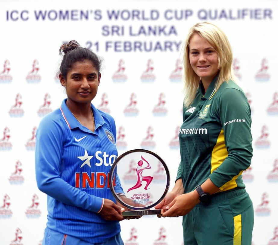Indian women's cricket team captain Mithali Raj (left) and her South African counterpart Dane van Niekerk pose for a photograph holding the ICC Women's World Cup Qualifier trophy in Colombo, Sri Lanka on Monday.