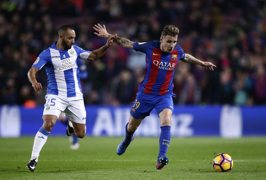 FC Barcelona's Lucas Digne (right) duels for the ball against Leganes' Nabil El Zhar during the Spanish La Liga soccer match between FC Barcelona and Leganes at the Camp Nou stadium in Barcelona, Spain on Sunday.