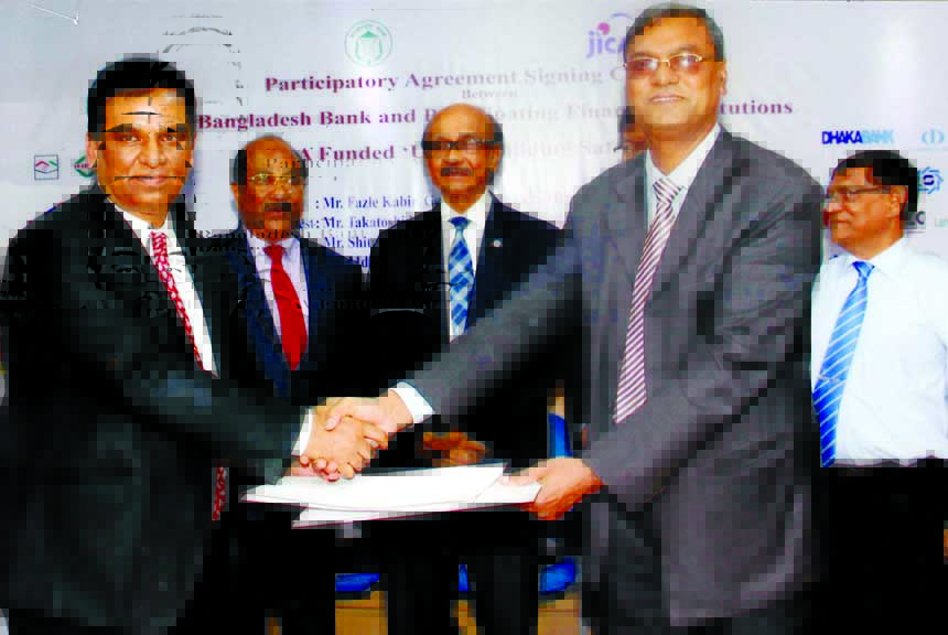Md Abdul Halim Chowdhury, Managing Director of Pubali Bank Limited and Swapan Kumar Roy, General Manager of Bangladesh Bank (BB) exchanging documents after signing a participatory agreement on 'Urban Building Safety Project' in the city recently. Fazle