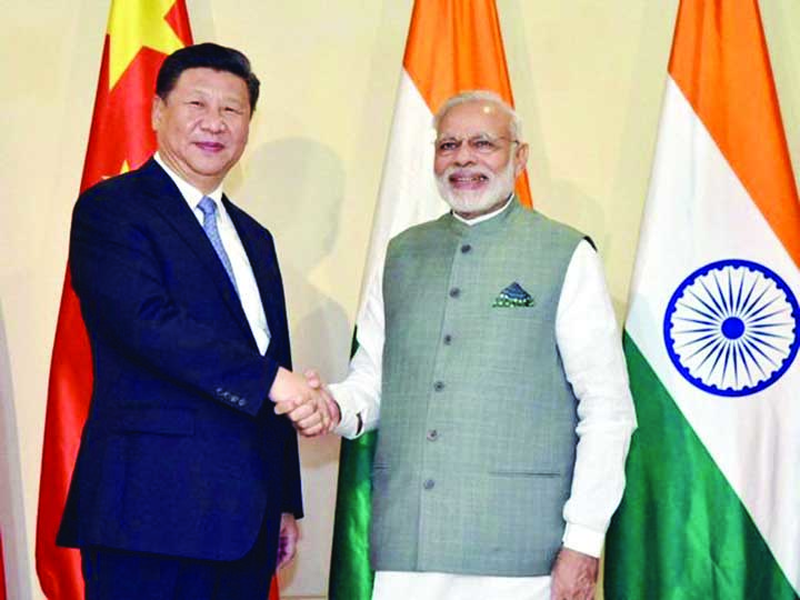 Prime Minister Narendra Modi shakes hands with Chinese President Xi Jinping ahead of the BRICS Summit, in Goa.