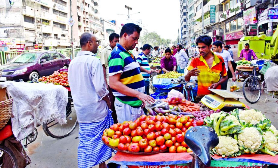 Main thoroughfare in city is being occupied illegally by the vendors of vegetables and fruits in name of holiday market causing sufferings to commuters and pedestrians. This photo was taken from Naya Paltan area on Friday.