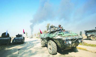 Iraqi troops advance towards Mosul's southern neighbourhood of Jawasaq on Friday during an ongoing offensive to retake the city from IS.