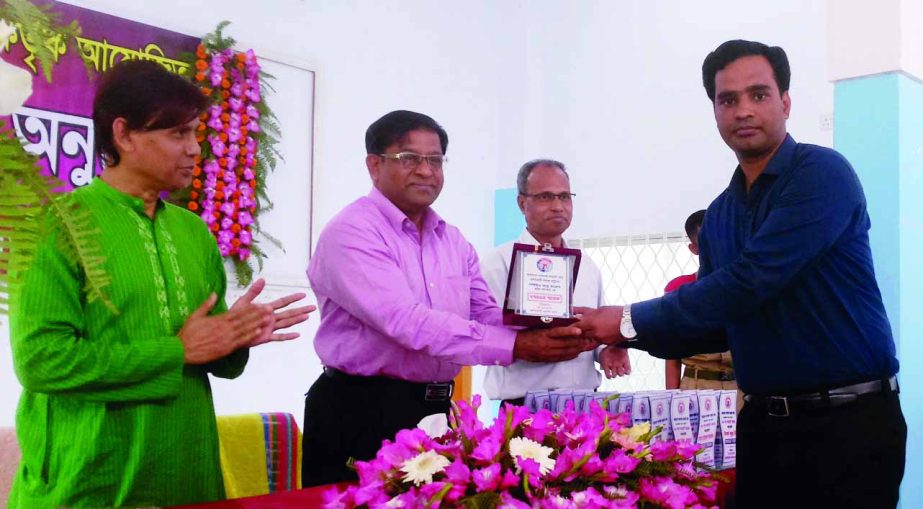 Mir Kafil Uddin, Principal, Hathazi College giving a crest to teacher Abu Taleb for his contribution BNCC activities recently.