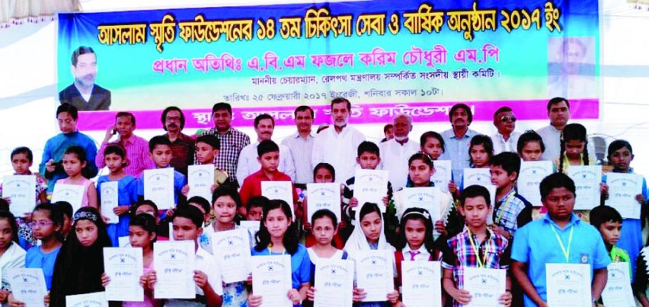 Chairman of the Parliamentary Standing Committee on Ministry of Railway ABM Fazle Karim Chowdhury MP seen alongwith the scholarship awarded students of Aslam Smriti Foundation in South Raozan, Chittagong yesterday.