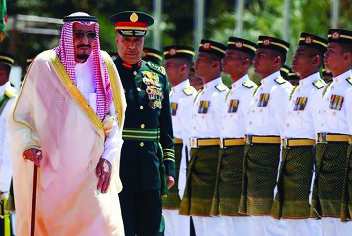 Saudi Arabia's King Salman inspects an honour guard at the Parliament House in Kuala Lumpur, Malaysia.