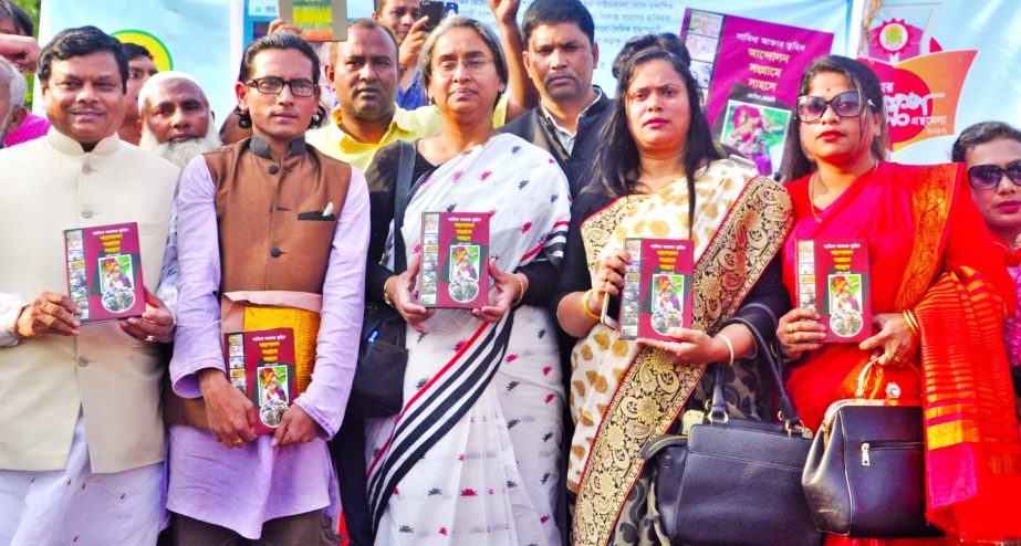 Former Foreign Minister Dr Dipu Moni, along with others holds the copies of a book titled 'Sabina Aktar Tuhiner Andolon Sangrame Sahose' written by Momin Mehedi at its cover unwrapping ceremony at Bangla Academy Book Fair on Suhrawardy Udyan premises in