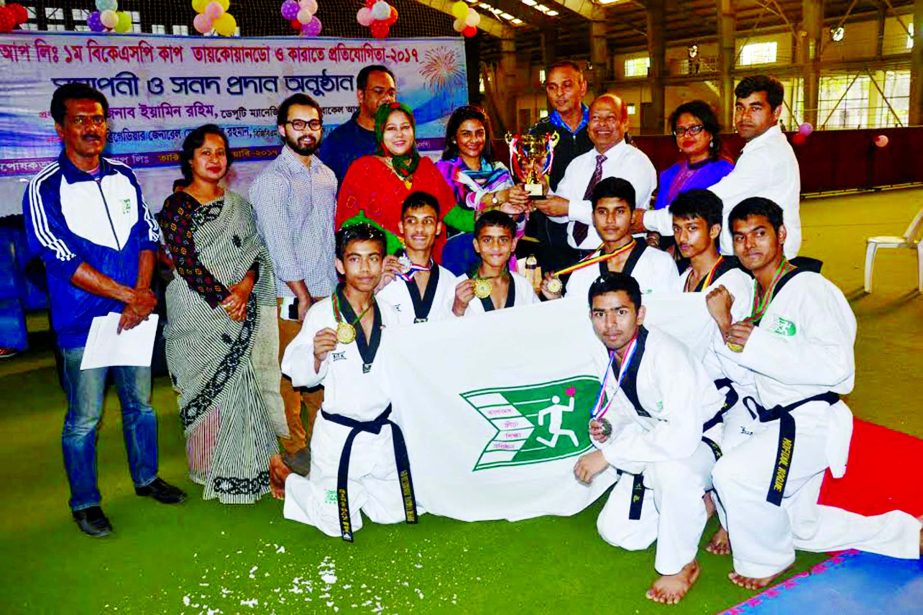 BKSP Teakwondo team, the champions of the 1st BKSP Cup Teakwondo Competition with the guests and officials of BKSP pose for a photo session at BKSP in Savar on Tuesday.