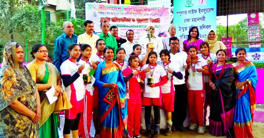 Wari Club, the champions of the Popular Life Insurance Dhaka Metropolis Open Women's Volleyball Competition with the guests and officials of Bangladesh Volleyball Federation pose for photograph at Volleyball Stadium on Tuesday.