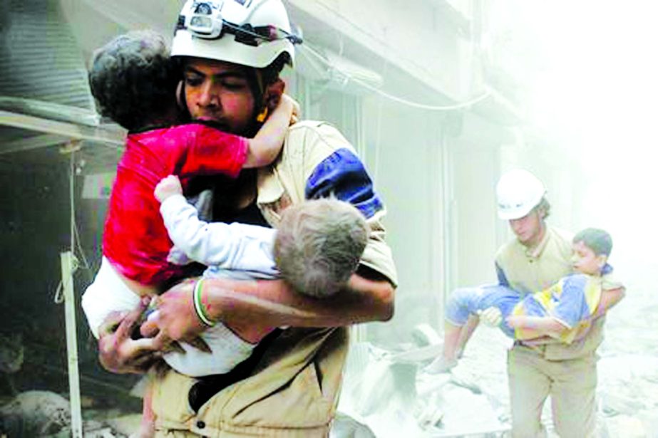 Members of the civil defense rescue children after what activists said was an air strike by forces loyal to Syria's President Bashar al-Assad in al-Shaar neighborhood of Aleppo.