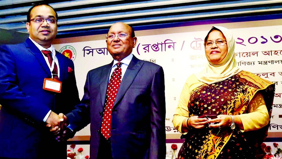 AHM Abdur Rahman, Director of Paramount Textile Ltd, shaking hands with Commerce Minister Tofail Ahmed MP after receiving CIP Award-2013 on behalf of Shakhawat Hossain, Managing Director of the company at a function in the city recently.