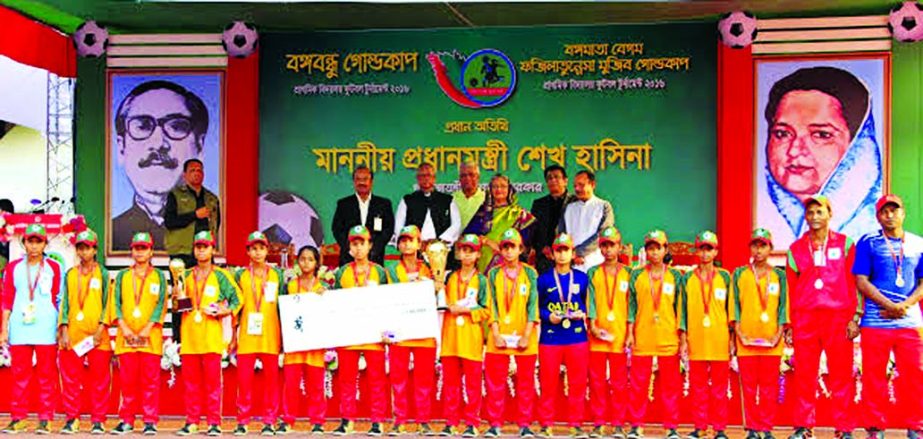 Members of Tepurgari BK Government Primary School of Lalmnirhat, the champions of the Begum Fazilatunnesa Mujib Gold Cup Primary School Football Tournament with the chief guest Prime Minister Sheikh Hasina pose for a photo session at the Bangabandhu Natio