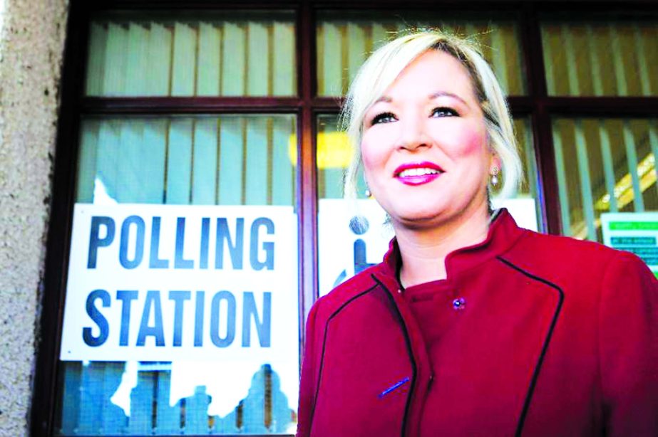 Sinn Fein's leader in Northern Ireland Michelle O'Neill leaves a polling station after casting her vote on Thursday .