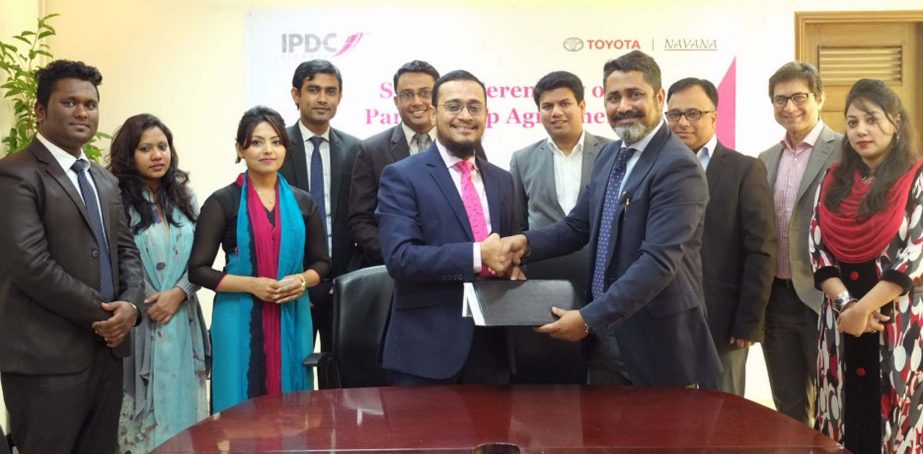 AFM Barkatullah, DMD of IPDC Finance Limited and Hamdur Rahaman Simon, Head of Operations, Navana Limited exchanging documents after signing an agreement in the city recently. Under the deal consumers can avail unique offers on selective models of Toyota