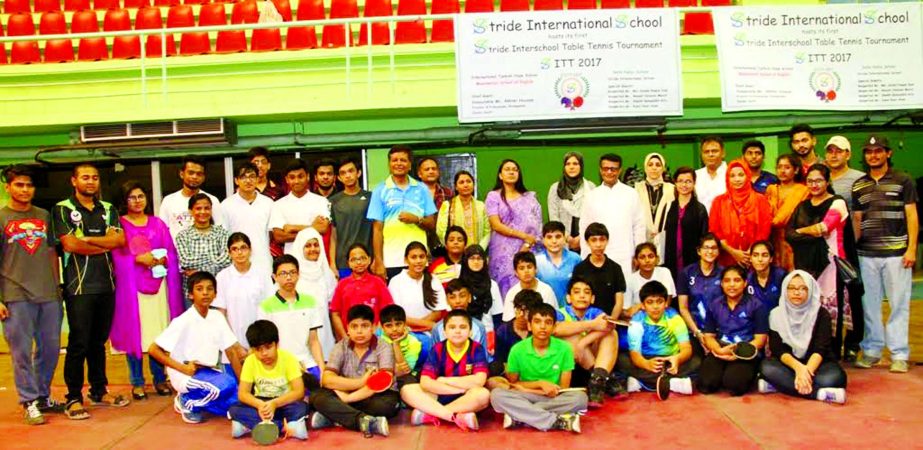 The participants of the Stride Inter-School Table Tennis Tournament with the guests pose for a photo session at the Shaheed Tajuddin Ahmed Indoor Stadium on Friday.