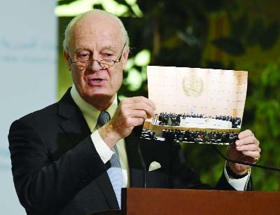 UN Special Envoy of the Secretary-General for Syria Staffan de Mistura shows a picture during a press conference as part of the Intra-Syrian peace talks at the European headquarters of the United Nations in Geneva on Friday.