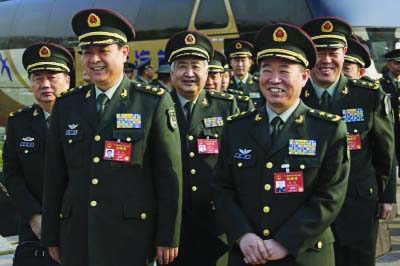 Delegates from China's People's Liberation Army (PLA) share a light moment as they arrive to attend a plenary session of the National People's Congress at the Great Hall of the People in Beijing on Saturday.