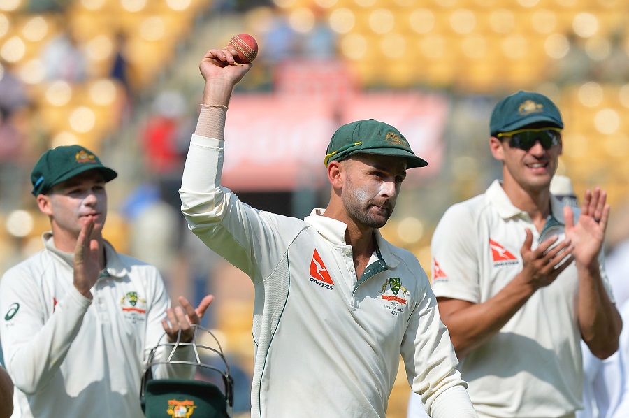 Nice Garry: Nathan Lyon holds the ball aloft up claiming 8 for 50 on the 1st day of 2nd Test between India and Australia at Bengaluru on Saturday.