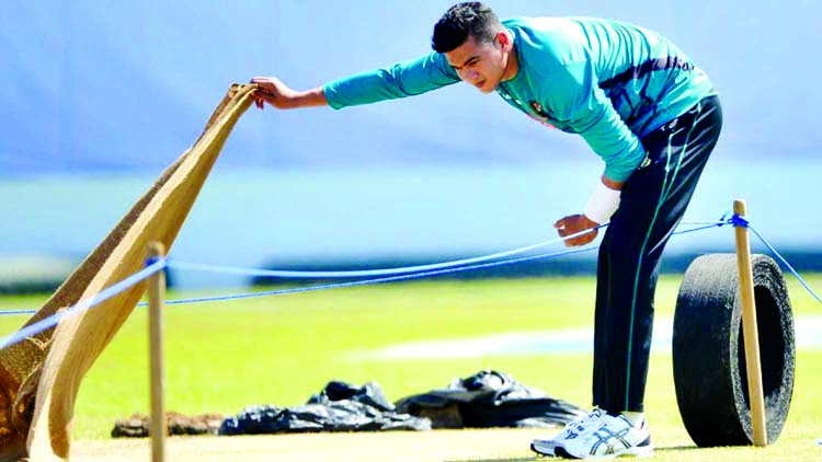 Taskin Ahmed inspects the pitch at Galle on Monday.